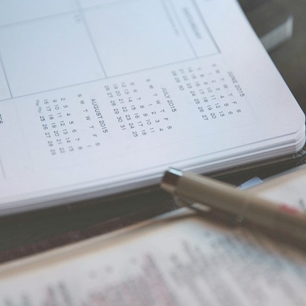 A calendar notebook layed out on a table