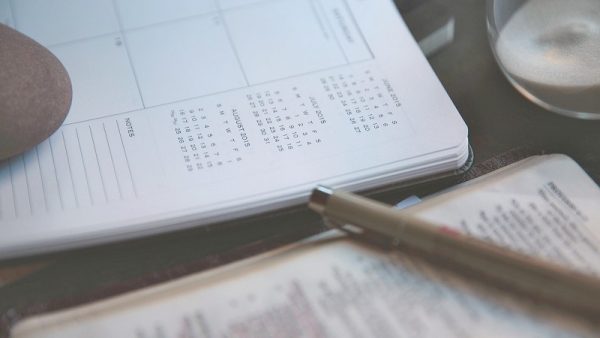 A calendar notebook layed out on a table