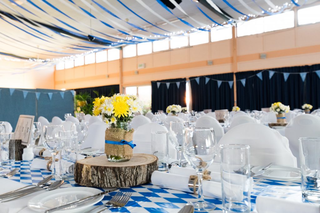 A formal event venue with white and blue decorations
