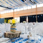 A formal event venue with white and blue decorations