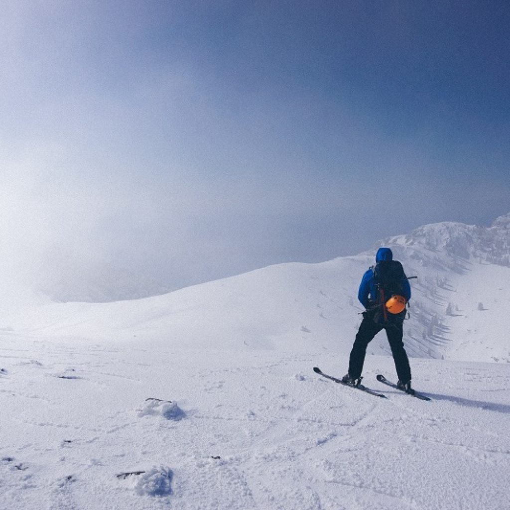 A person skiing on top of a snow covered mountain