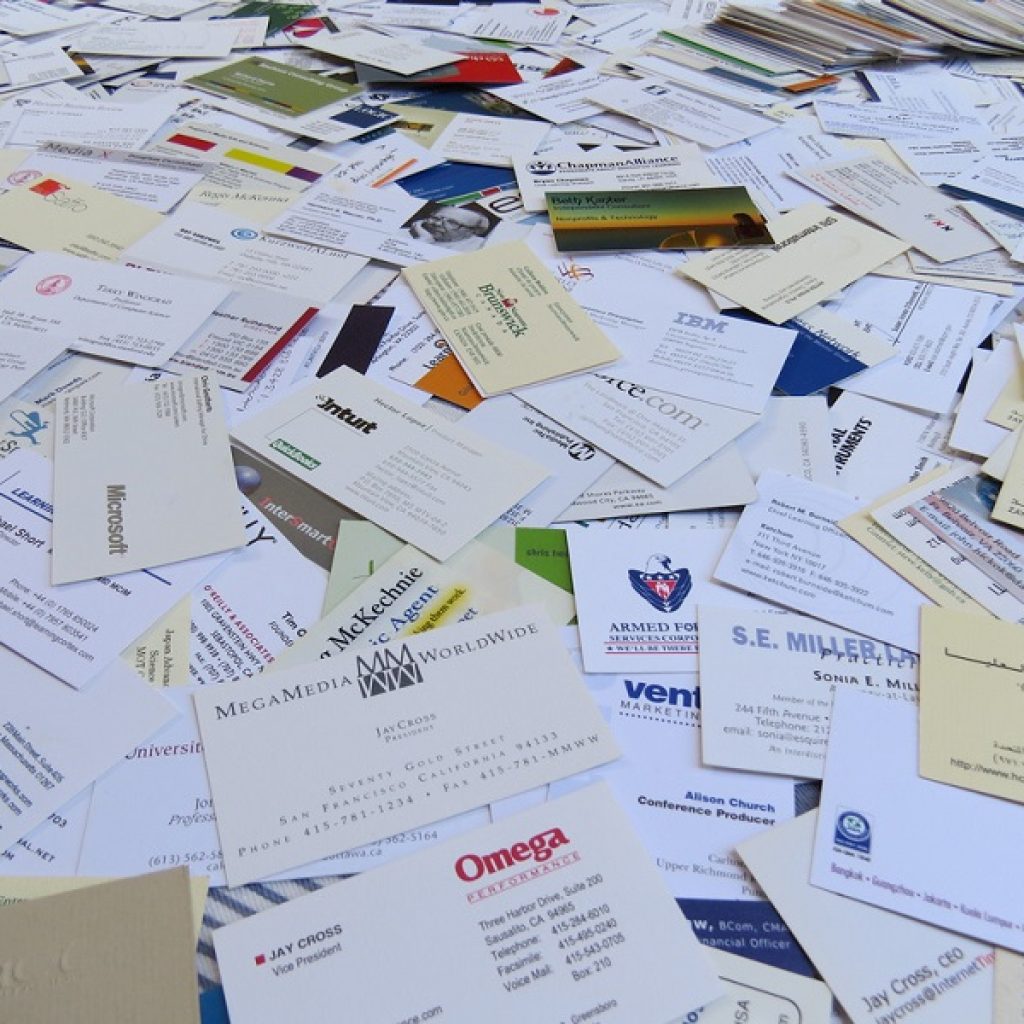 A large stack of various business cards covering the entire surface