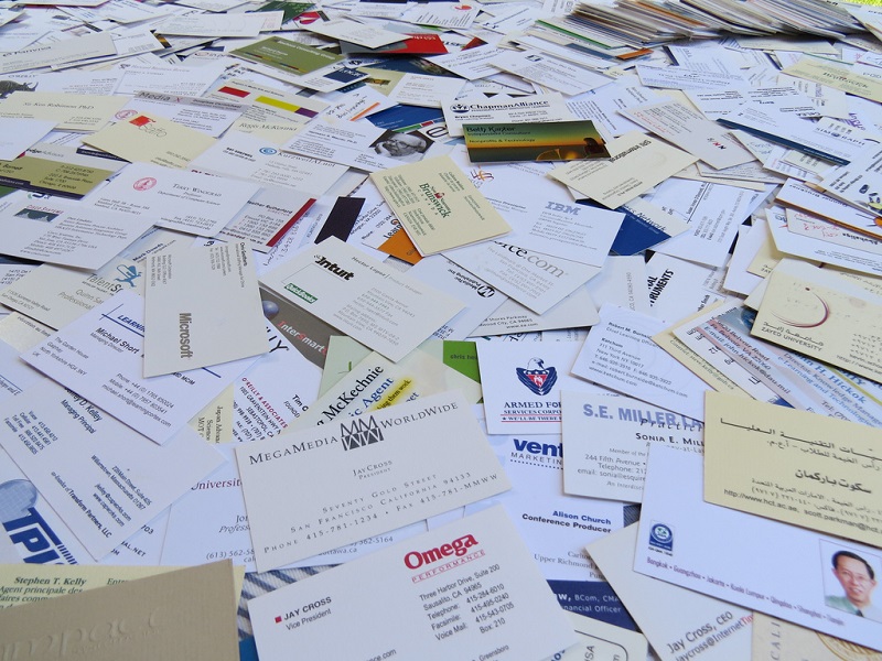 A large stack of various business cards covering the entire surface