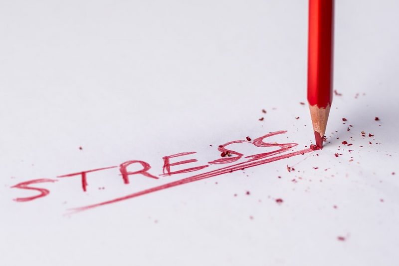 The words stress written with a read pencil breaking on impact