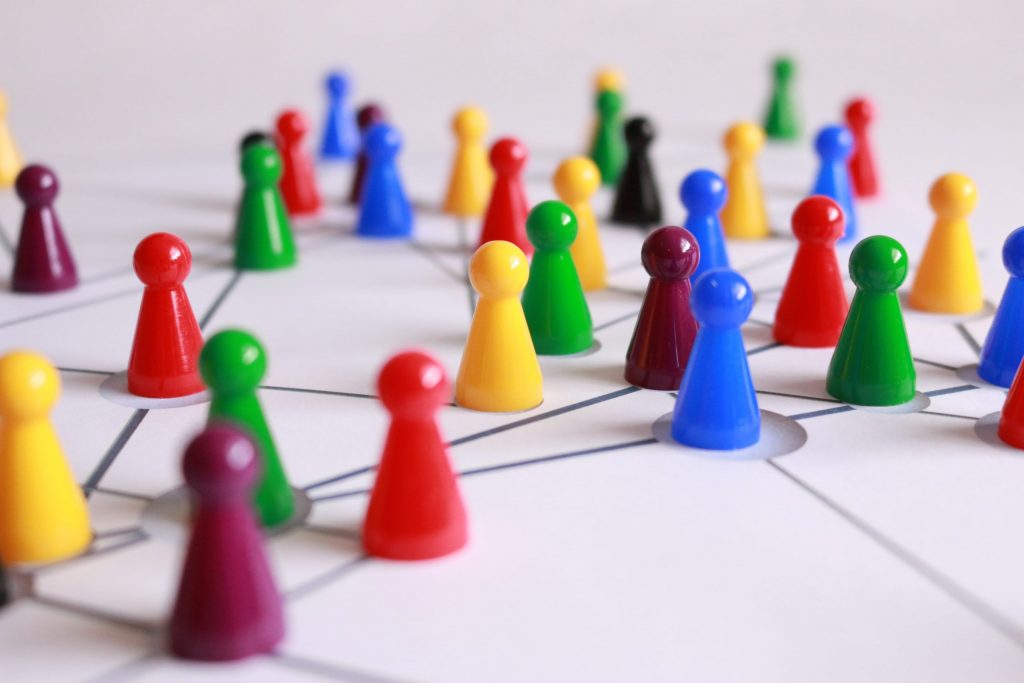 A network of colourful game pawns connected by straight lines crossing over