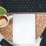 Working space with a keyboard, tea cup, plant and snack bowl