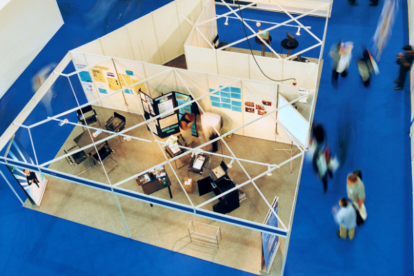 Shot from above showing a business trade show with blue exhibit colours