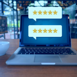 Laptop computer with two speech bubbles emitted from the screen displaying five star reviews
